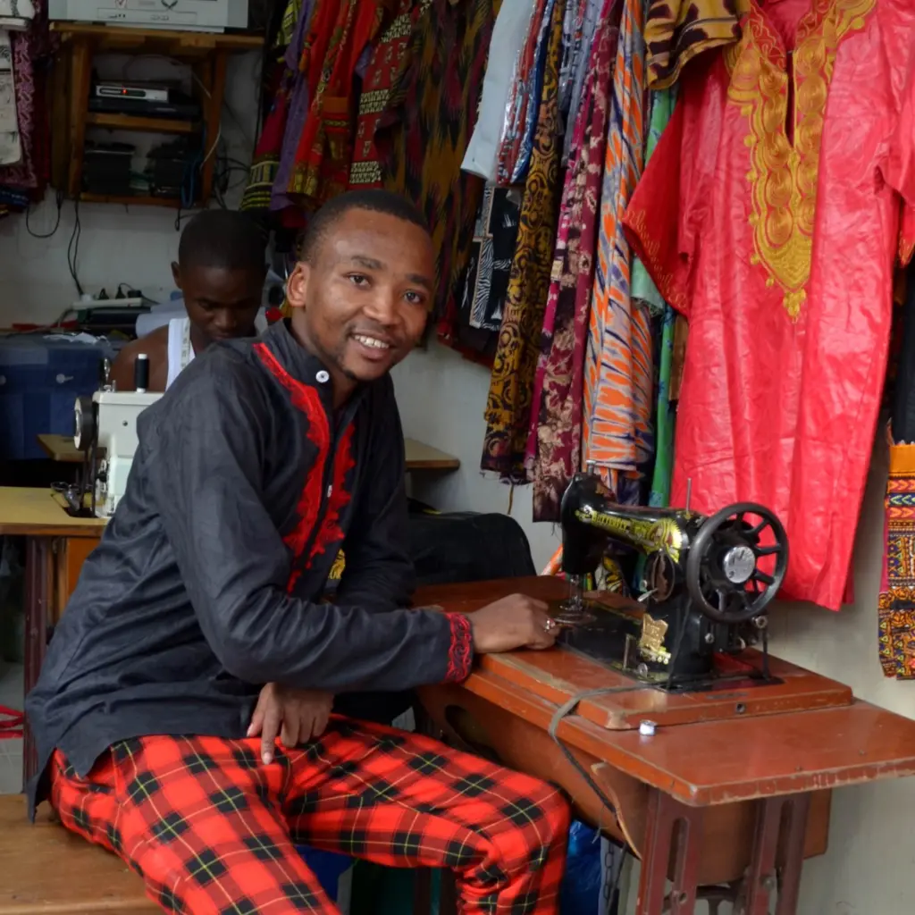 Msafiri Raphael next to a sewing machine